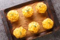 Tender homemade muffins made with potato, onion, bacon and cheddar cheese close-up on a wooden tray. horizontal top view Royalty Free Stock Photo