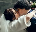 A tender kiss of beautiful newlyweds Royalty Free Stock Photo