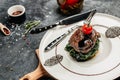 Tender lean medium rare beef fillet steak medallions with one sliced through to show the red meat with spinach, Restaurant menu, Royalty Free Stock Photo