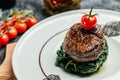 Tender lean medium rare beef fillet steak medallions with one sliced through to show the red meat with spinach, Restaurant menu,