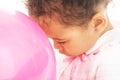 Tender little girl with a pink balloon