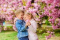 Tender love feelings. Little girl enjoy spring flowers. Giving all flowers to her. Surprising her. Kids enjoying pink Royalty Free Stock Photo