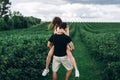 A tender loving couple walking in a field of currant. Man whirls woman in her arms. Love story Royalty Free Stock Photo