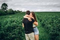 A tender loving couple walking in a field of currant. Man whirls woman in her arms. Love story Royalty Free Stock Photo