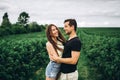 A tender loving couple walking in a field of currant. Man whirls woman in her arms. Love story Royalty Free Stock Photo