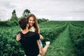 Young loving couple gently hugging on the background of green currant plantations. Love Story Royalty Free Stock Photo