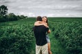 Young loving couple gently hugging on the background of green currant plantations. Love Story Royalty Free Stock Photo