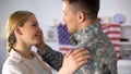 Tender military soldier holding face of beloved woman, rejoicing homecoming