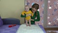 Tender mom with cute baby girl make squat exercises. 4K