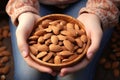 Tender moment childs hand holds a bowl filled with almonds