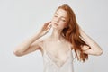 Tender nude redhead model posing with closed eyes. Royalty Free Stock Photo