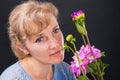 Tender pensive woman 45 years old with flowers Royalty Free Stock Photo