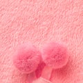 Tender pink texture of towel like background with pompons, close Royalty Free Stock Photo