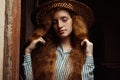 Tender redhead model with closed eyes in straw hat posing in pas Royalty Free Stock Photo