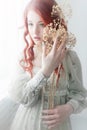 Tender retro portrait of a young beautiful dreamy redhead woman. Royalty Free Stock Photo