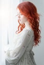 Tender retro portrait of a young beautiful dreamy redhead woman. Royalty Free Stock Photo