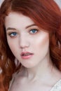 Tender retro portrait of a young beautiful dreamy redhead woman. Royalty Free Stock Photo