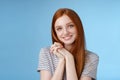 Tender romantic sincere young redhead teenage girl found love look sympathy delight press palms together cute pose Royalty Free Stock Photo