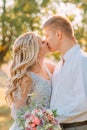 Tender and sensual kiss of the bride and groom on wedding day, the girl in a luxurious elegant dress with transparent Royalty Free Stock Photo