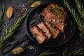 Tender sliced sous-vide beef steak from in a cast iron pan