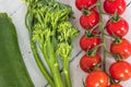 Tender stem Broccoli a small string of tomatoes and a Single Courgette Royalty Free Stock Photo
