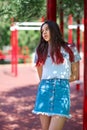 A trendy girl in fashionable hipster clothes on a blurred natural background. Fashion, outdoors, youth concept. Copy space.