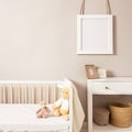 Tender toddler baby room with empty mockup photoframe for your picture, text, banner. Bed, toys, table, basket. Frame Royalty Free Stock Photo