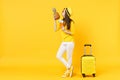 Tender traveler tourist woman in hat holding passport tickets, kissing pineapple fruit isolated on yellow orange