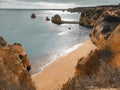 A tender unity of the warm shining sea and the mild sand among the ridiculously shaped rocks