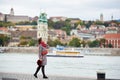 Tender woman enjoys lonely embankment of Budapest with blurred view