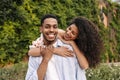 Tender young african couple enjoys leisure time walking in nature sunny weather. Royalty Free Stock Photo