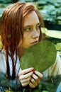 Tender young woman swimming in the pond among water lilies Royalty Free Stock Photo