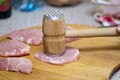 Tenderize slabs of meat on wooden board Royalty Free Stock Photo