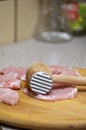 Tenderize slabs of meat on wooden board Royalty Free Stock Photo
