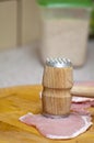 Tenderize slabs of meat on wooden board Royalty Free Stock Photo