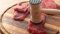 Tenderizing Beef Steaks on Board. Royalty Free Stock Photo