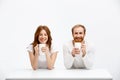 Tenderless redhead girl and boy drinking coffee sitting at w Royalty Free Stock Photo