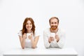 Tenderless redhead girl and boy drinking coffee sitting at w Royalty Free Stock Photo