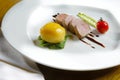 Tenderloin with vegetables on a white plate