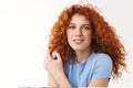 Tenderness, beauty and women concept. Alluring sensual young woman with reddish curly hair gently touching shoulder