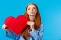 Tenderness, relationship and valentines day concept. Caring and romantic cute foxy teenage girlfriend holding red heart