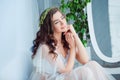 Tenderness and sensuality concept. Beautiful brunette model posing on bed in white lingerie. Sensual portrait of young Royalty Free Stock Photo