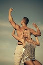 Tenderness and strength concept. Woman and man holding hands on blue sky Royalty Free Stock Photo