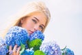 Tenderness of young skin. Springtime bloom. Girl tender blonde hold hydrangea flowers bouquet. Natural beauty concept Royalty Free Stock Photo