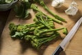Tenderstem Brocolli on Wooden background with Sharp Knife Royalty Free Stock Photo