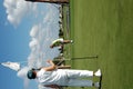 Tending flag on golf green Royalty Free Stock Photo