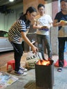 Tending the Ghost Festival Fire