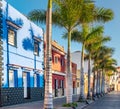 Tenerife. Colourful houses and palm trees on street in Puerto de la Cruz town Royalty Free Stock Photo