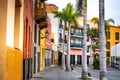 Tenerife. Colourful houses and palm trees on street in Puerto de la Cruz town, Tenerife, Canary Islands, Spain Royalty Free Stock Photo