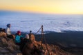 Hikers watching sunrise from top of the El Teide volcano